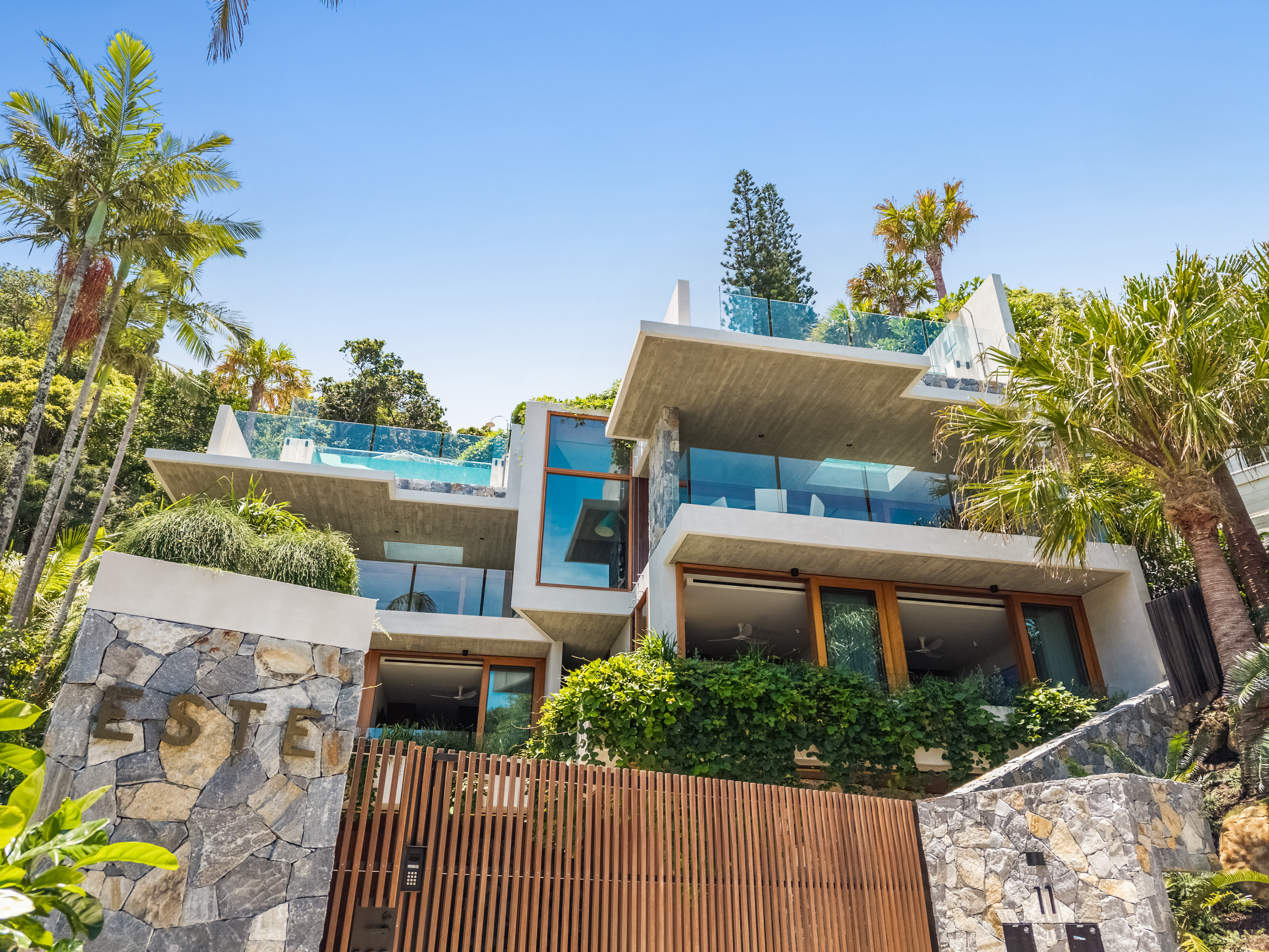 Close aerial of the home and surrounding rainforest canopy — property photographer Byron Bay