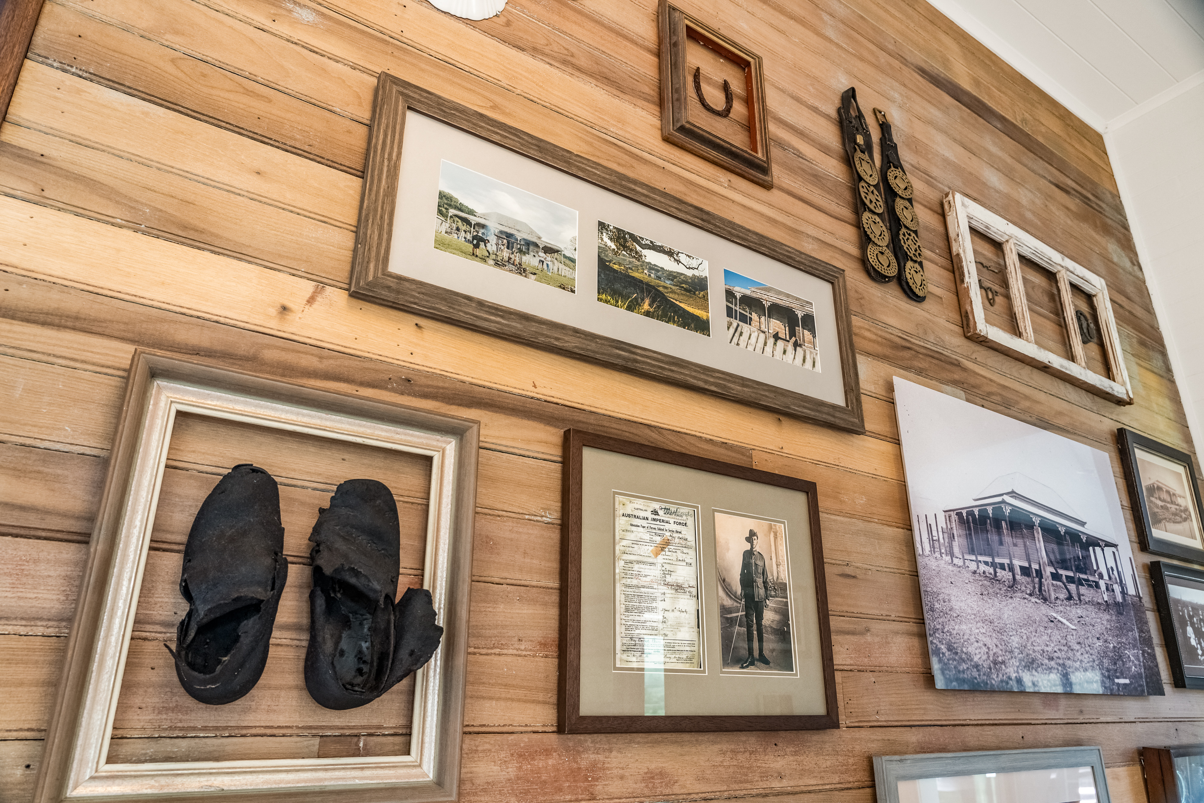 Detail of the history wall with heritage photographs, horseshoe and original documents