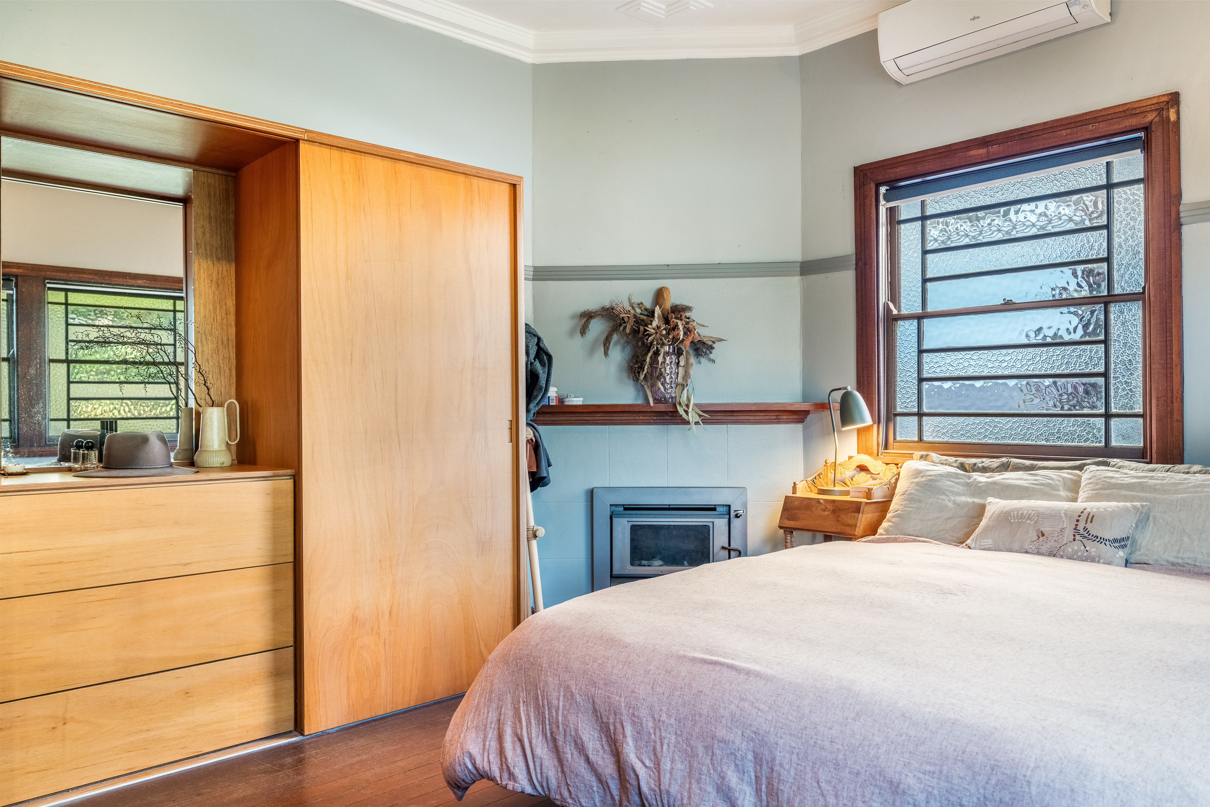 Bedroom with fireplace and timber wardrobe
