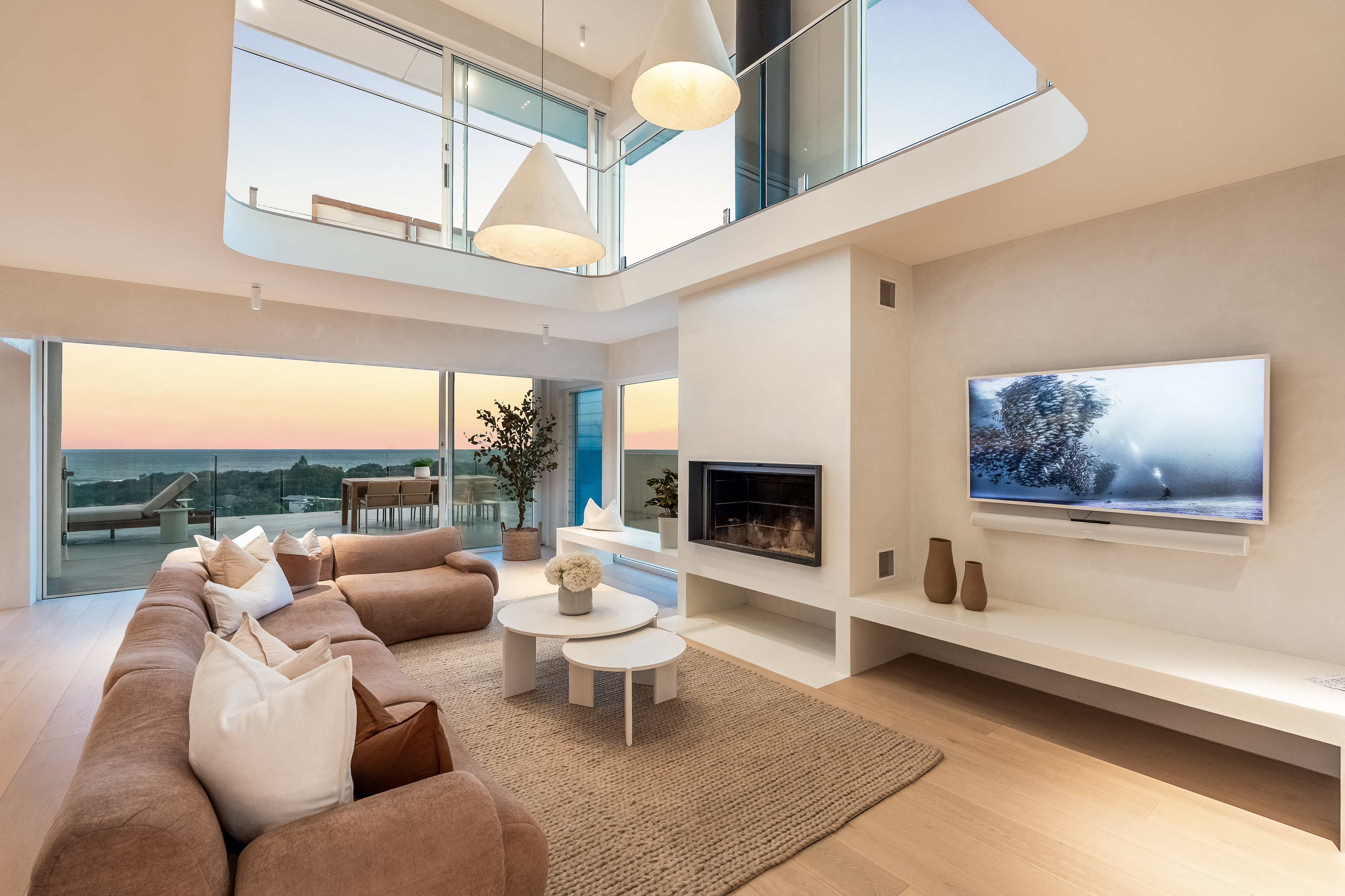 Double-height living room with ocean views — interior real estate photography Byron Bay