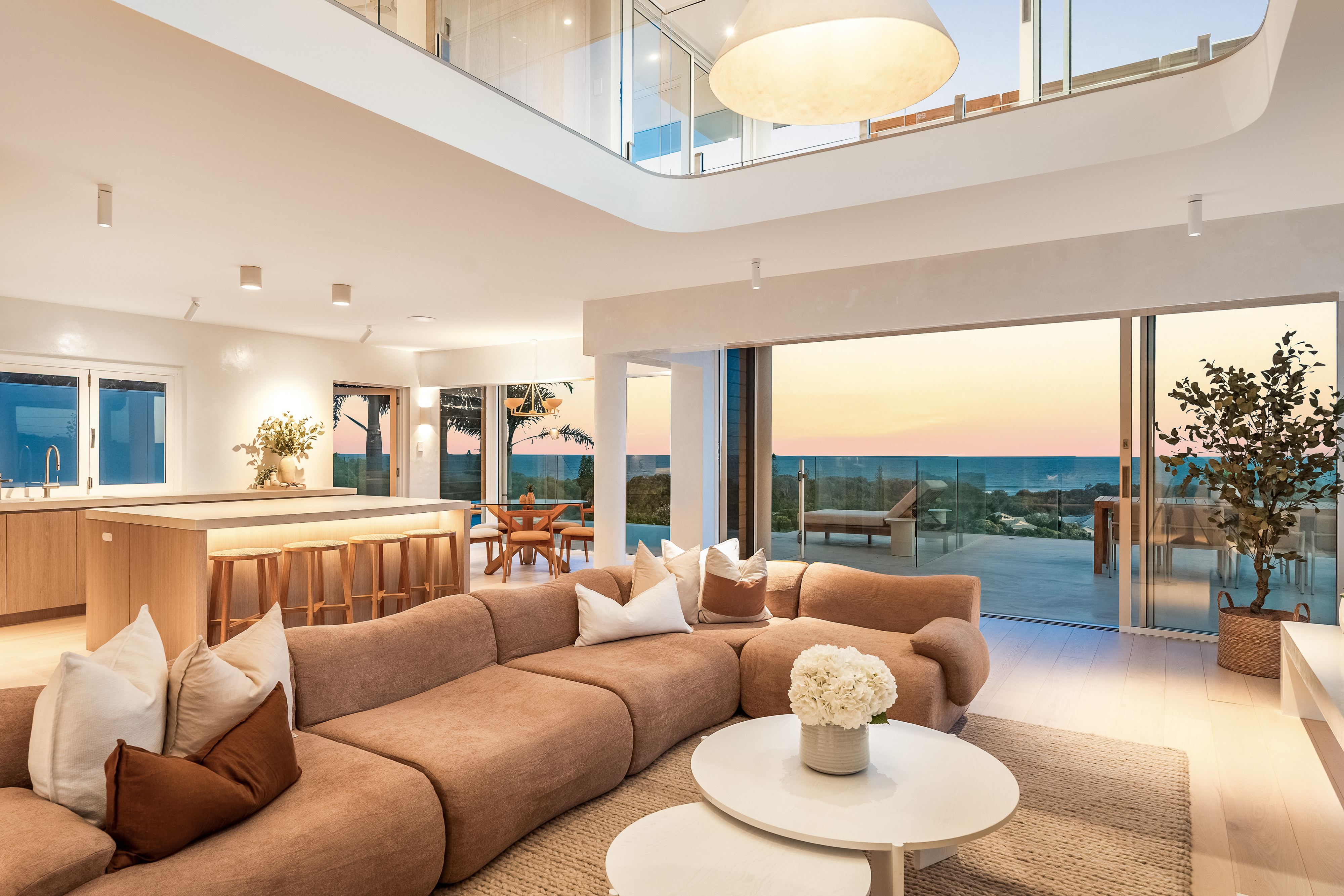 Infinity pool with panoramic ocean views — twilight property photography Byron Bay