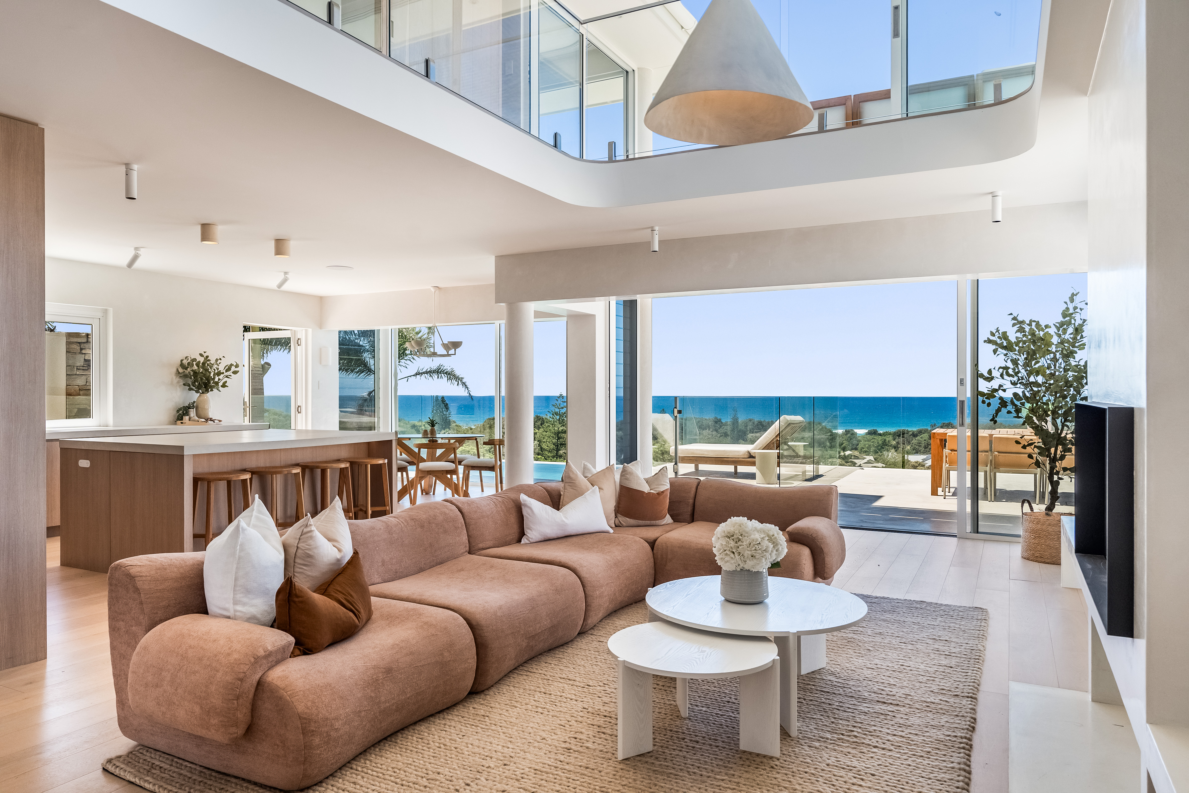 Open-plan living and kitchen at dusk — professional real estate photography, Byron Bay