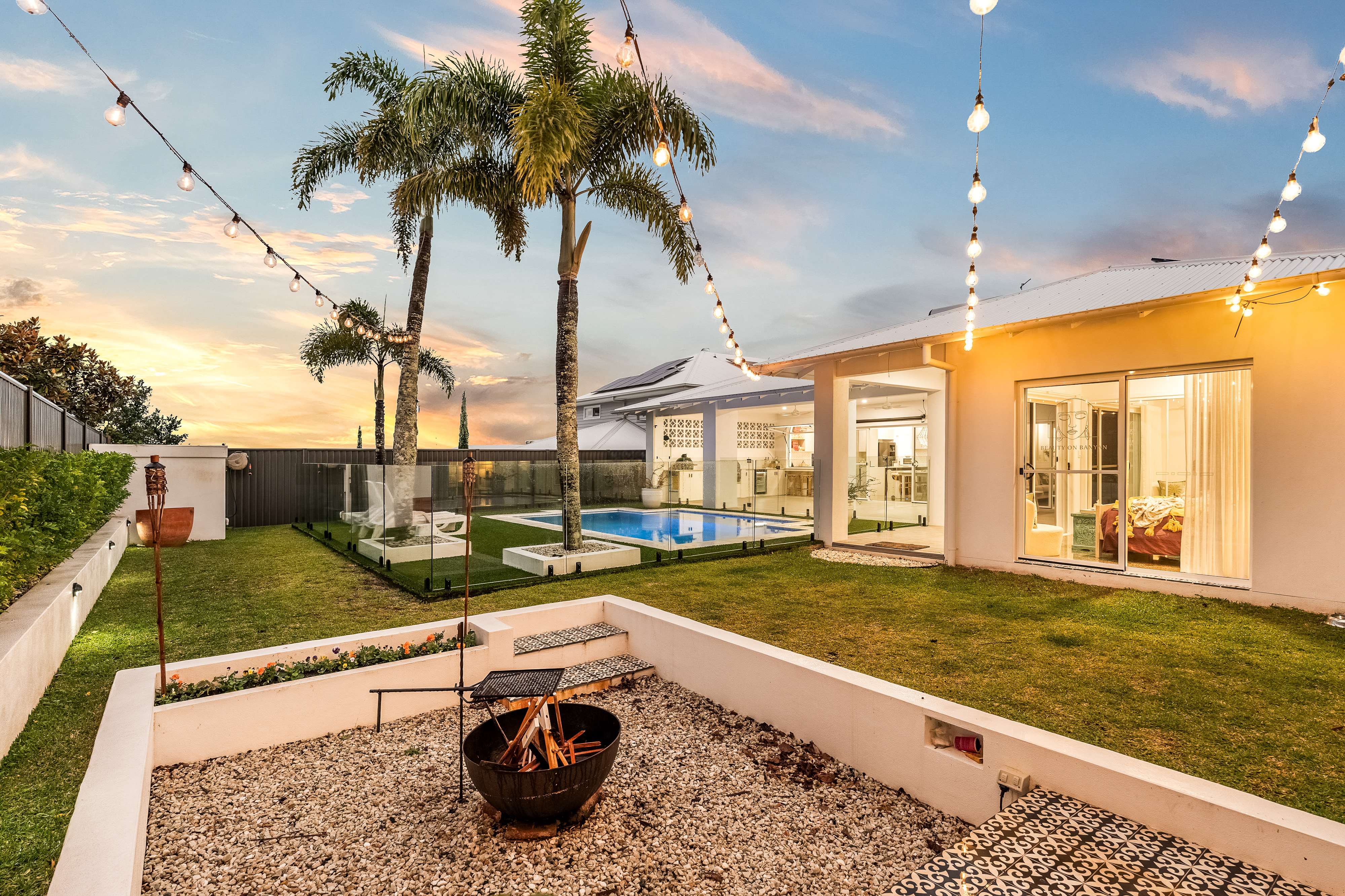Fire pit and pool area at dusk with festoon lights — professional property photographer Northern Rivers