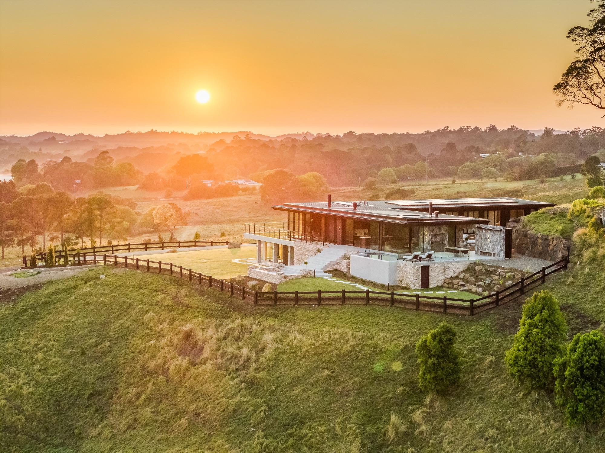 CODA estate at sunrise showing architectural home perched on Myocum Ridge with 120 acres of hinterland