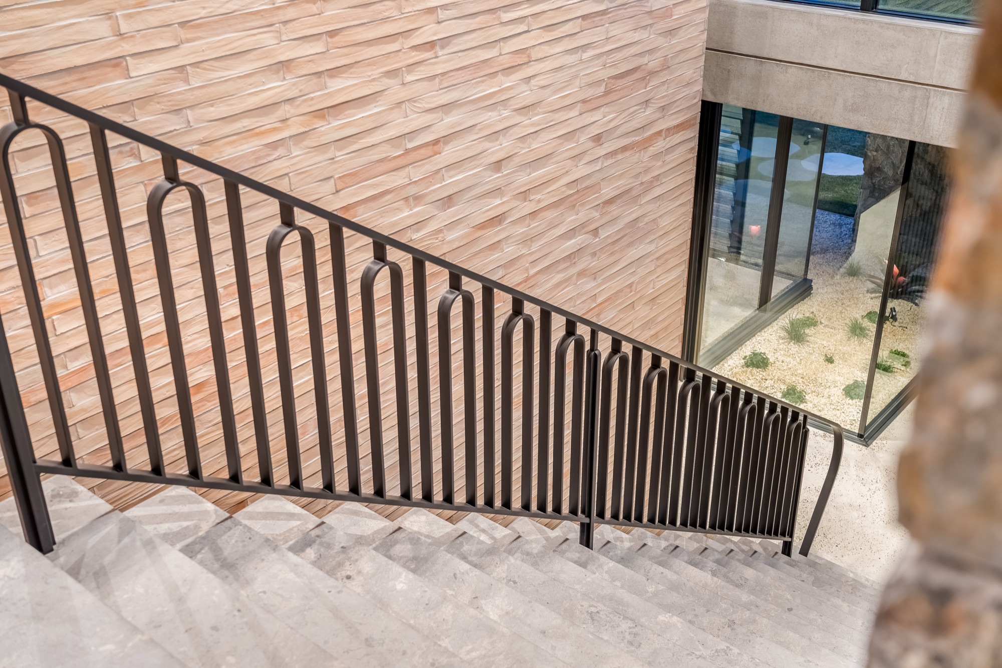 Custom ironwork staircase detail with brick and timber cladding