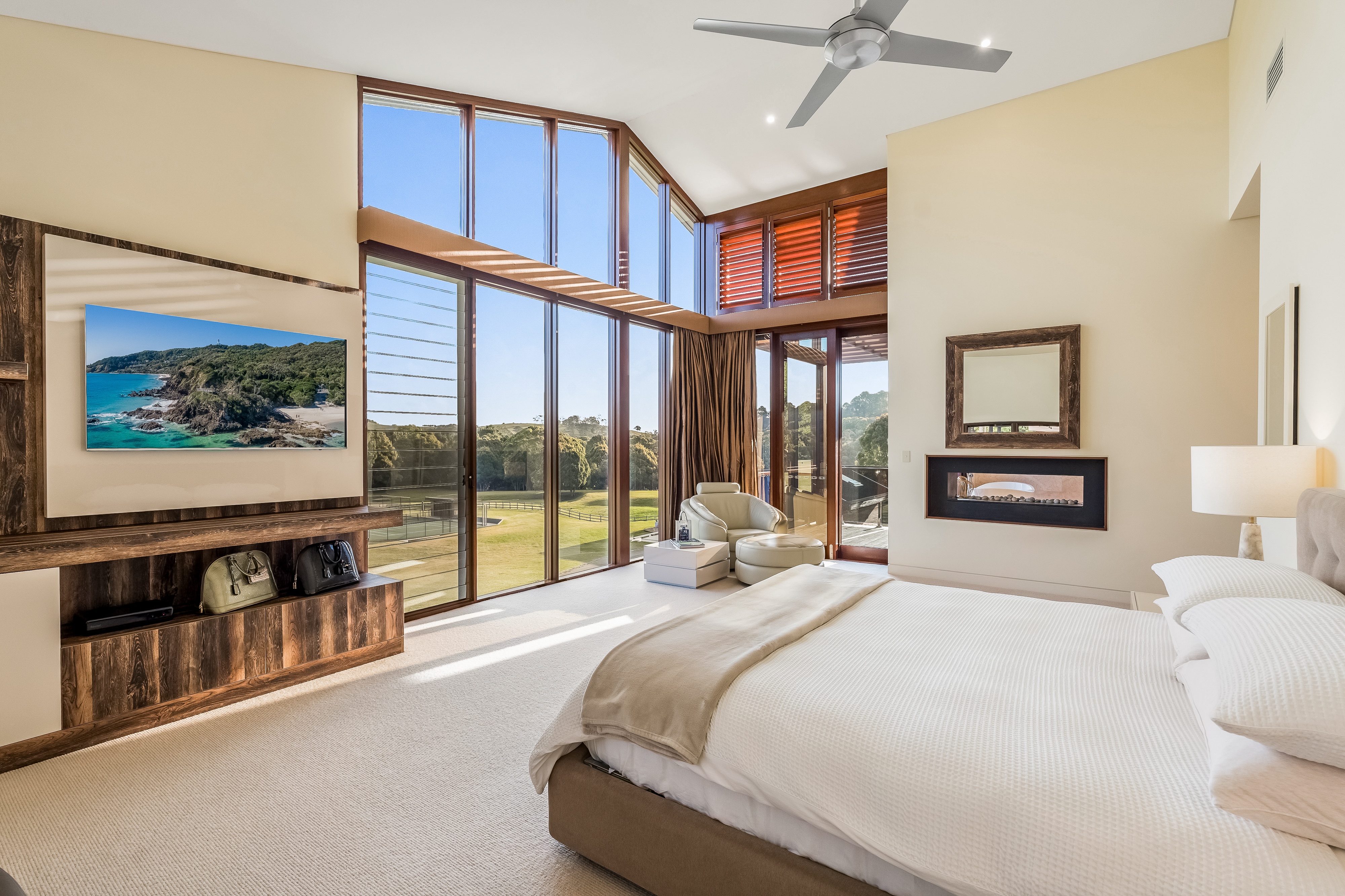 Master bedroom with double-height windows and hinterland views — interior real estate photography Bangalow